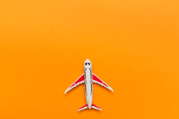 istock Small airplane model on color background, top view 1488904460