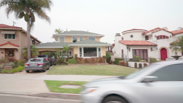 Passenger Side View: Shaky Process Plate of Classic Vibrant-Colored Homes and BnB Rentals along Ocean Boulevard in Long Beach, Los Angeles, California on an Overcast Day