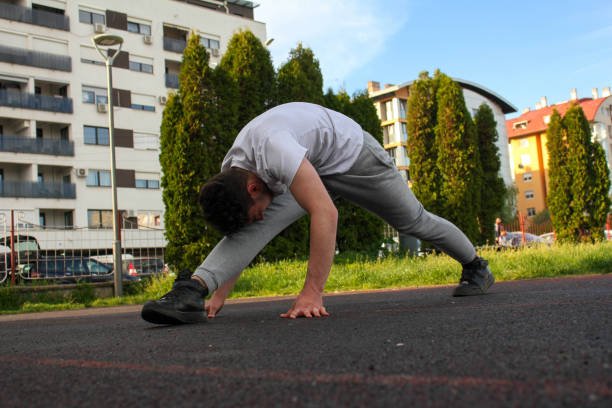 istock A white man stretching himself in a public park 1488910107