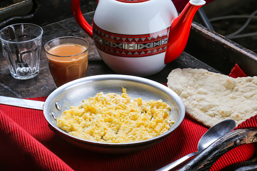 Egg with Cheese omelet with coffee, teapot served in dish isolated on red mat top view on table arabic food