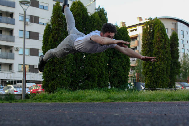 istock A white man jumping from the ground while doing a pushup in a public park 1488911894