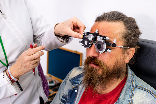 Optician and optometrist. Eye doctor helps your patient with their visual health.