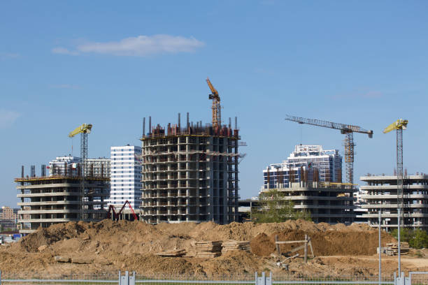 istock Construction site. Reinforced concrete frames of multi-storey buildings and construction cranes. Against the background of the blue sky. 1488914973