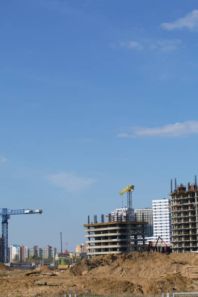 istock Construction site. Reinforced concrete frames of multi-storey buildings and construction cranes. Against the background of the blue sky. 1488915163