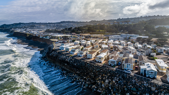 High quality aerial stock photo of a mobile home park along the coast in Norther California.