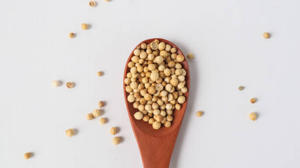 istock coriander on a spoon made of wood on the table 1488920527
