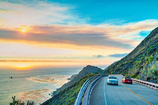 Cars drive on the Pacific Coast Highway at Big Sur in California, USA