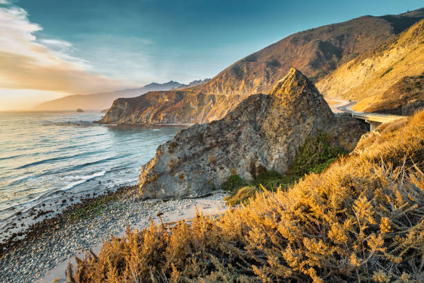 Big Sur Beach Highway California USA Sunset at Big Sur coastline with the Pacific Coast Highway in California, USA rocky coastline stock pictures, royalty-free photos & images