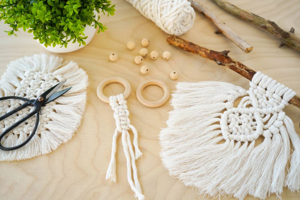 istock A Hand-Made Macrame amulet with Wooden Rings in a Beautiful Background Setting the Mood for Creativity. textile produced using macrame technique 1488923383