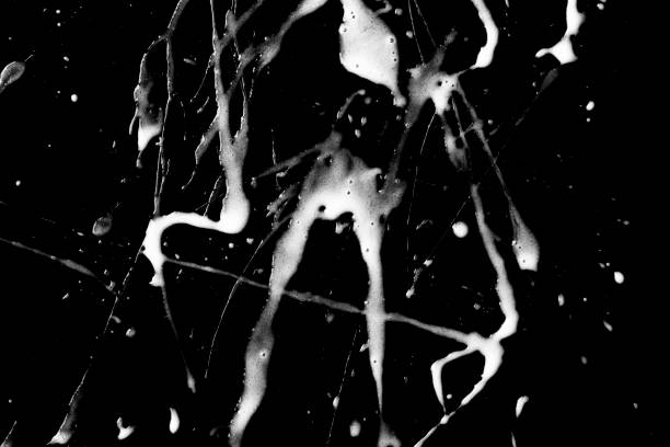 istock Streaks of white cream isolated on black background. 1488923748