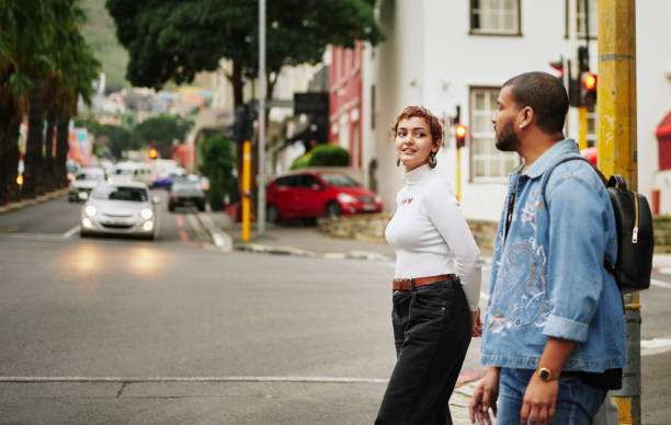 istock Young multi-ethnic non-binary and gay friend talking while walking together in the city 1488924813