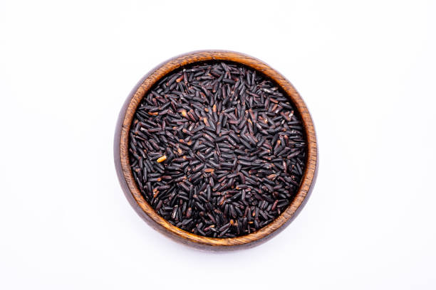 istock Raw black rice in the bowl on white background 1488926761