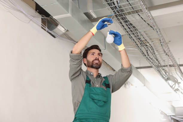 istock Professional electrician changing light bulb in room 1488927007
