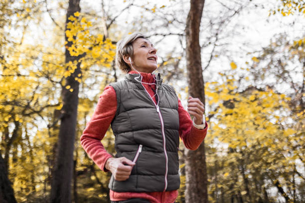 istock Senior woman jogging in park 1488928510