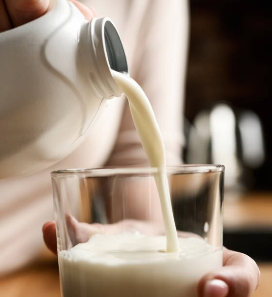 istock Girl with milk at kitchen at home 1488929415