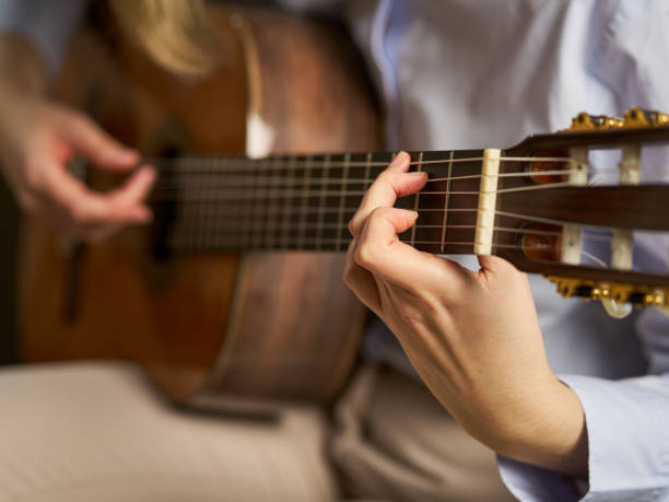 istock an unrecognizable person playing the spanish guitar playing a chord 1488929457