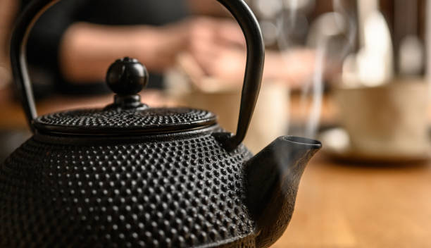 istock Black metal teapot with hot tea at the kitchen 1488929498