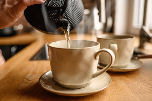 istock Tea preparation with teapot and cups at kitchen 1488929563