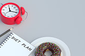 Inscription diet plan on notepad near donut and alarm clock. Healthy eating. Calorie control. Nutritionist consultation. Meal schedule. Slimming concept. Copy space. 3d render slimming