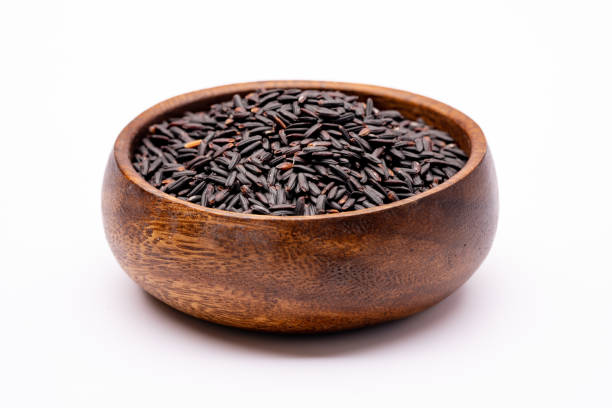 istock Raw black rice in the bowl on white background 1488934835