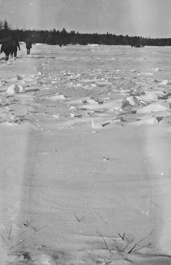 Workers crossing the frozen landscape of Cold Lake to get to the Sherritt Gordon Mine camp in Manitoba, Canada. Vintage photograph ca. 1928.