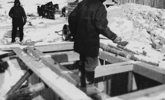 Kississing Lake, Manitoba, Canada - March 1928. Men at the Sherritt Gordon Mines No. 1 east ore zone shaft at Kississing Lake in Manitoba, Canada. Vintage photograph ca. 1928.
