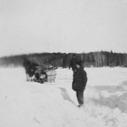 Kississing Lake, Manitoba, Canada - March 1928. Men hauling equipment to the Sherritt Gordon Mines at Kississing Lake in Manitoba, Canada. Vintage photograph ca. 1928.