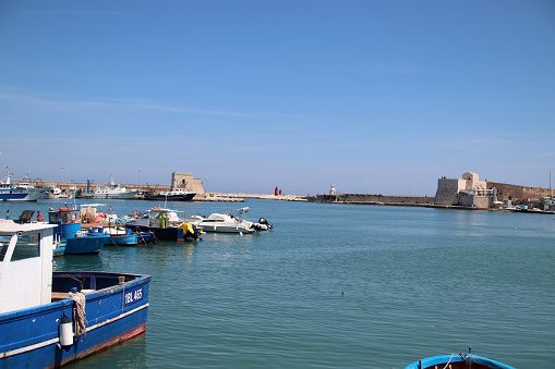 Trani, Province of Barletta-Andria-Trani, Italy - 7 may 2023: the pier of San Nicola and the pier of Sant'Antonio with their respective ighthouses, the pier of Santa Lucia and the fort