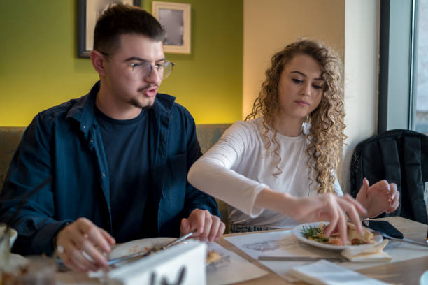 istock Happy smiling couple having fun while eating pizza 1488936126