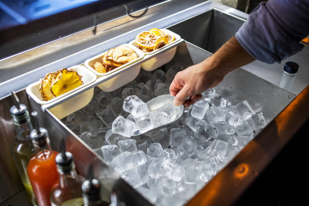 istock Bartender putting ice cubes in a glass. 1488937589