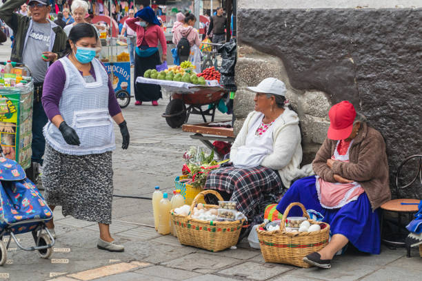 Cuenca, Ecuador - April 1, 2023: City life. Two elderly women vendors sell eggs in historical center of Cuenca. Ecuador