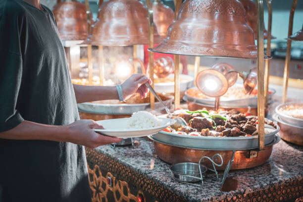 Young boy taking food at hotel restaurant buffet