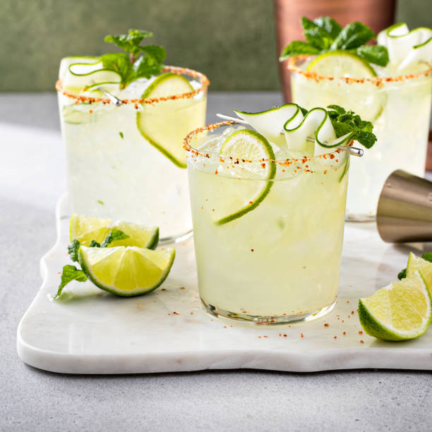 Cucumber margarita with lime and spicy rim Cucumber margarita with lime and spicy rim, refreshing spring cocktail with copy space lime basil plant stock pictures, royalty-free photos & images