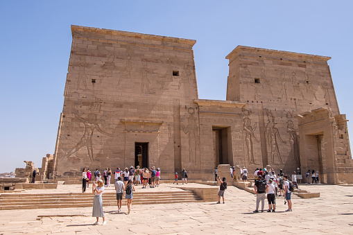 Aswan, Egypt - April 28, 2023: Tourist and Philae temple dedicated to the goddess Isis on the islet of Agilkia