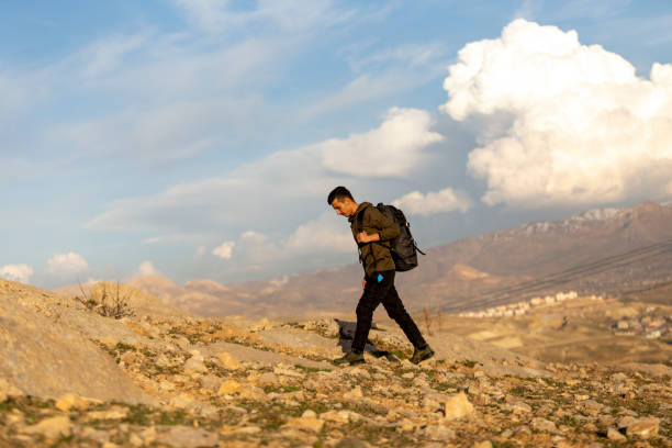 istock Male athlete hiking in mountainous area with backpack. 1488945979