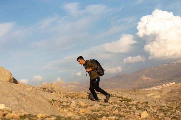 istock Male athlete hiking in mountainous area with backpack. 1488947342
