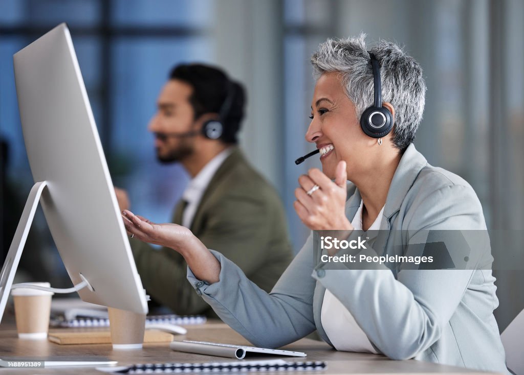Senior woman, call center and consulting in telemarketing, customer service or support at office desk. Happy elderly female consultant smile with headset for marketing, help or consultation advice Call Center Stock Photo