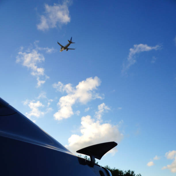 istock View past airport to airplane flying 1488953593