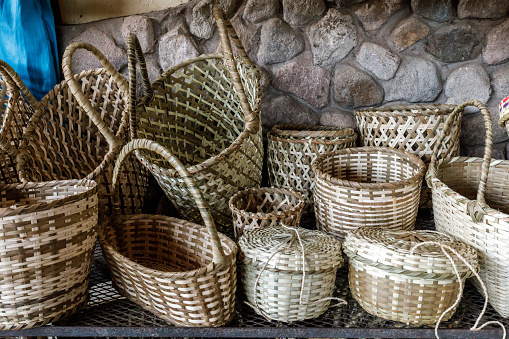 Lots of different woven wicker baskets on the ground.