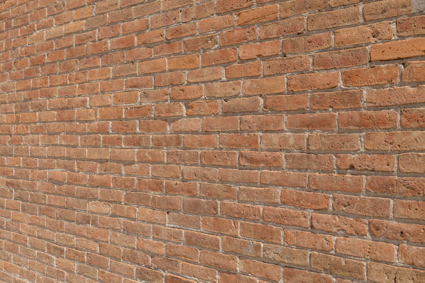 istock Antique exterior reddish brown clay brick wall texture background (angle view) 1488960102