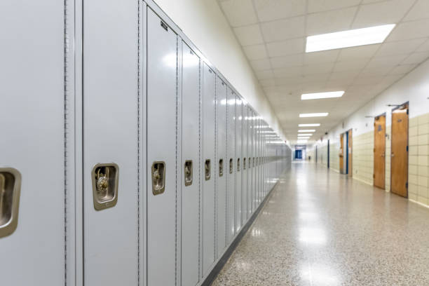 istock Empty middle school or high school hallway with gray student lockers 1488960775