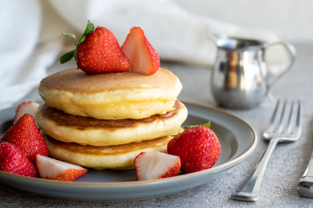 istock Red strawberries and yellow pancakes in silver and gray 1488962683