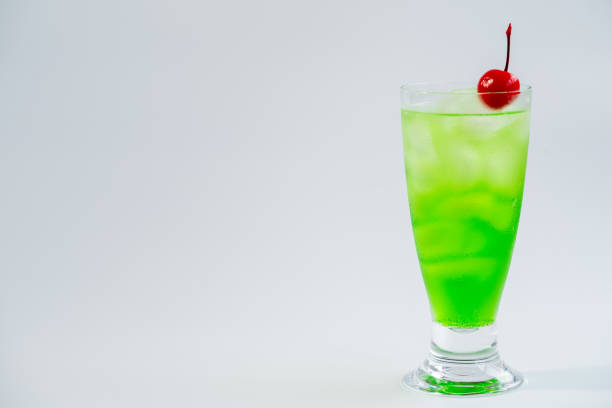 A detailed close-up view of a refreshing green drink with slices of oranges floating on top.