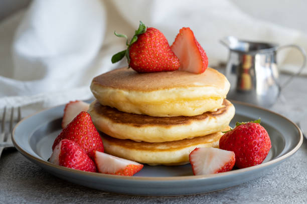 istock Red strawberries and yellow pancakes in silver and gray 1488962813