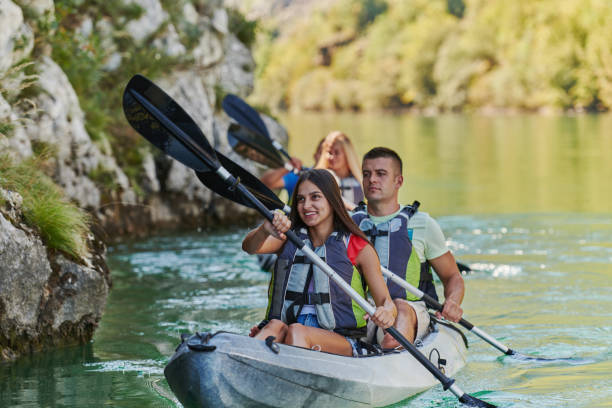 istock A group of friends enjoying having fun and kayaking while exploring the calm river, surrounding forest and large natural river canyons 1488963928