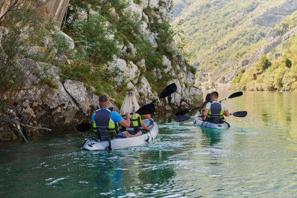 istock A group of friends enjoying having fun and kayaking while exploring the calm river, surrounding forest and large natural river canyons 1488964052