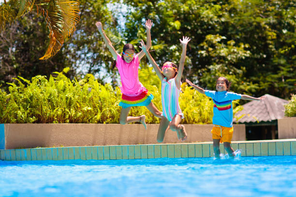 istock Kids jump into swimming pool. Summer water fun. 1488964098