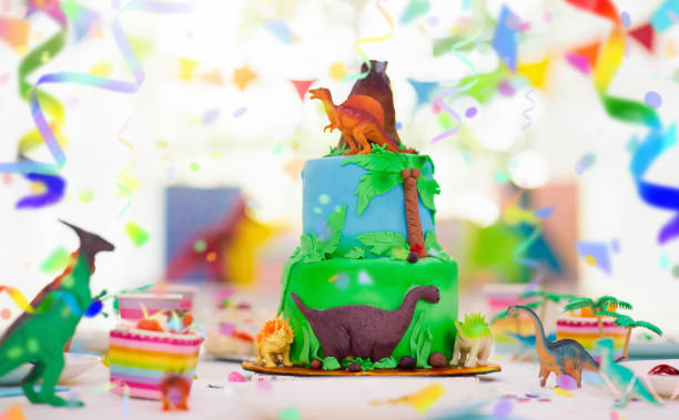 istock Kids birthday party. Dinosaur theme cake. 1488964120