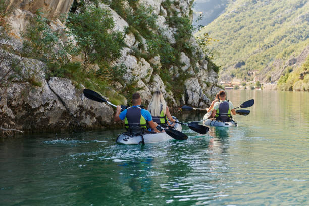 istock A group of friends enjoying having fun and kayaking while exploring the calm river, surrounding forest and large natural river canyons 1488964141