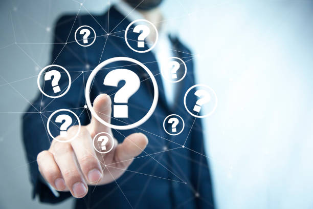 istock Businessman on blurred background holding hand drawn question marks 1488972629